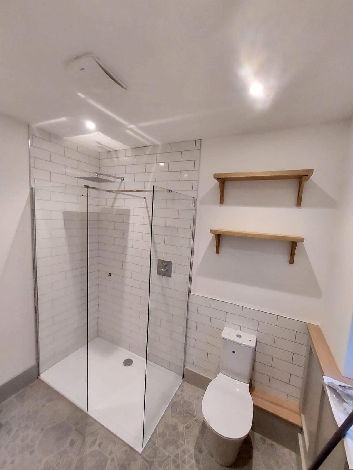Shower with metro tiles and oak shelves