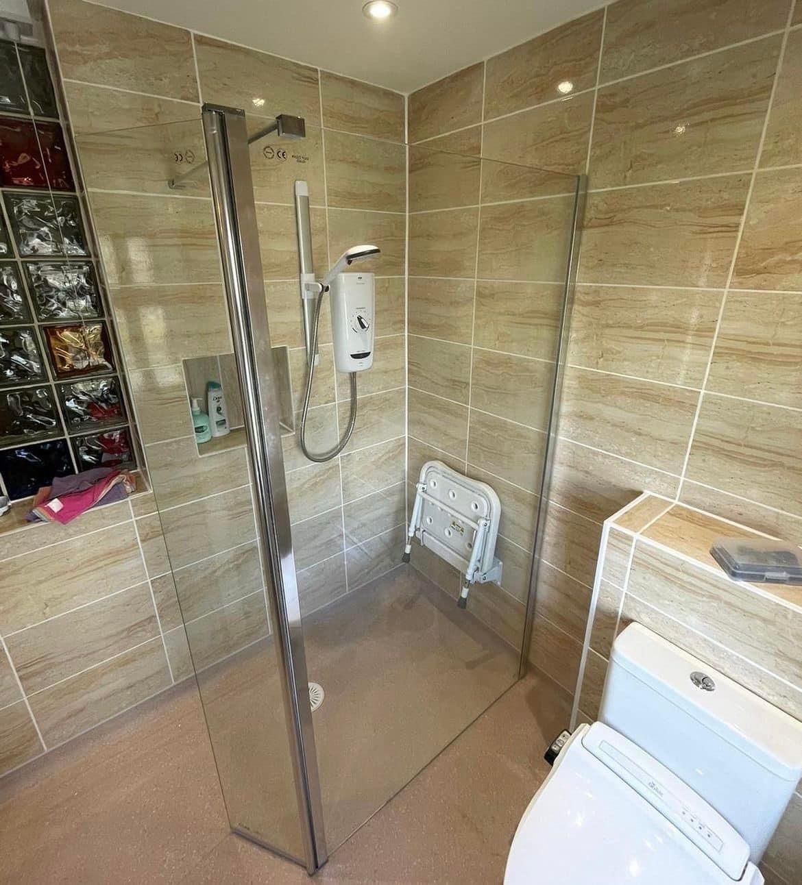 Level-access walk-in shower with a fold-down seat